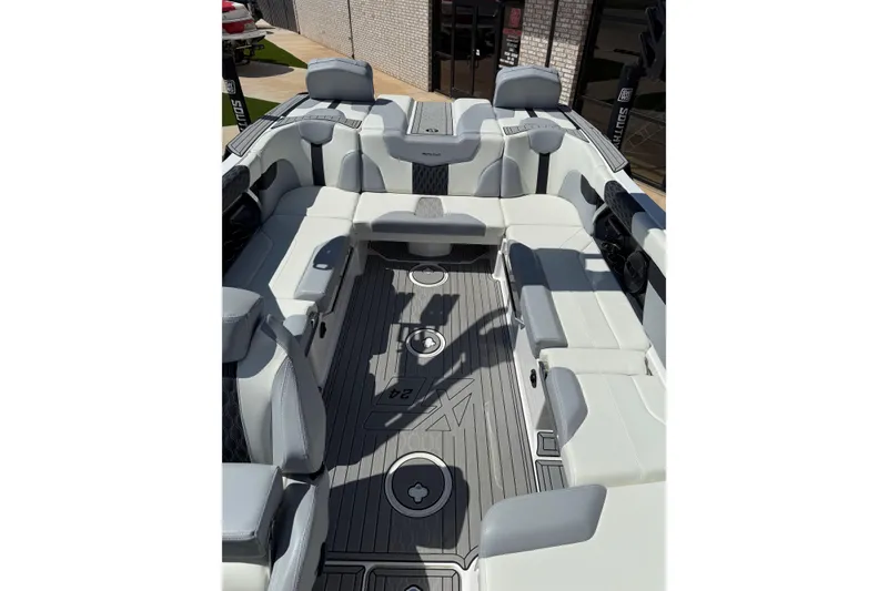 Slide: The Image of 2023 MasterCraft XT24 boat interior with luxurious seating and sleek design. - 13