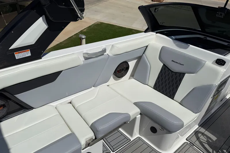 Slide: The Image of 2023 MasterCraft XT24 boat interior with white and gray seating, featuring modern design elements. - 14