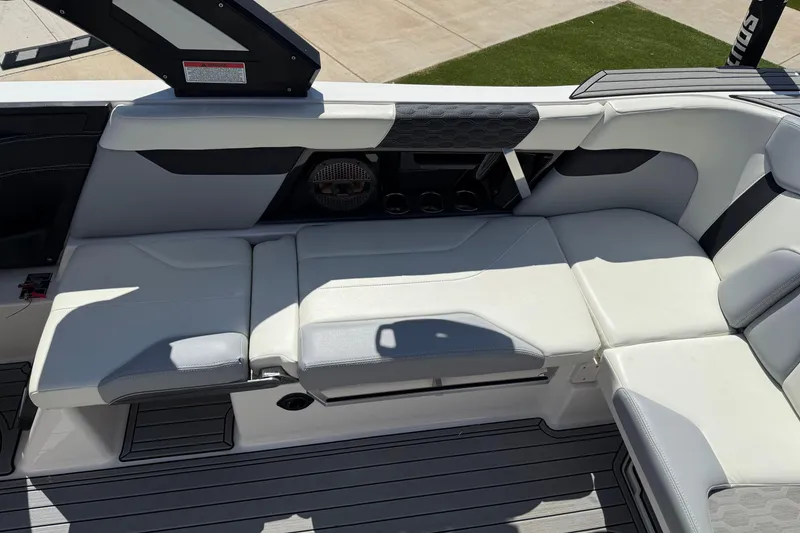 Slide: The Image of 2023 MasterCraft XT24 boat interior with sleek white seating and modern design elements. - 15