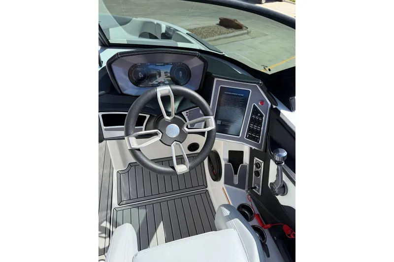 Slide: The Image of 2023 MasterCraft XT24 boat cockpit with modern steering wheel and digital dashboard. - 16