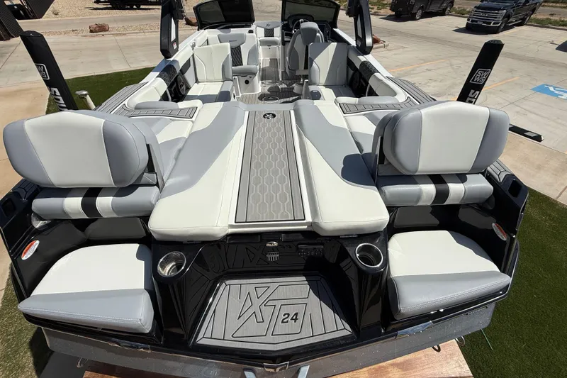 Slide: The Image of 2023 MasterCraft XT24 boat interior with luxurious seating and modern design. - 9