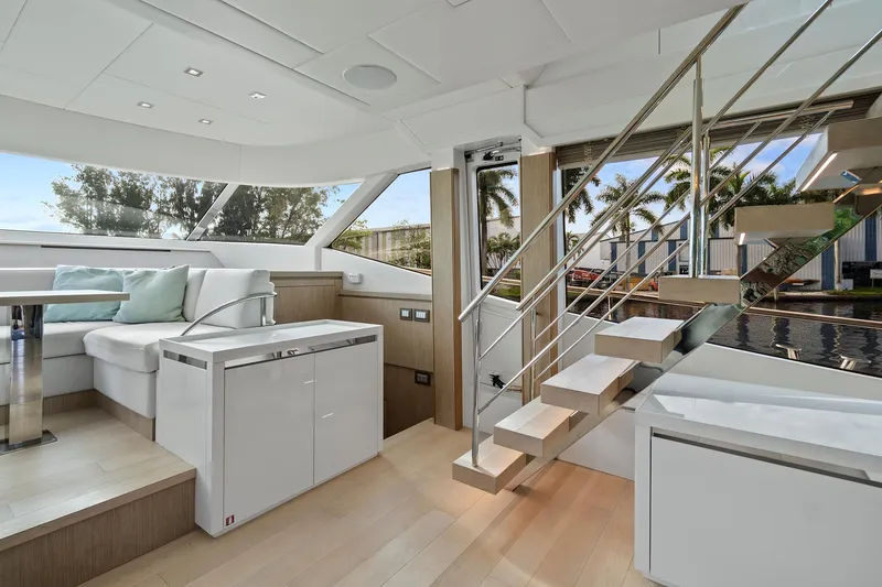 Slide: The Image of Luxurious interior of 2021 Monte Carlo Yachts MCY 76 Skylounge with modern seating and staircase. - 11