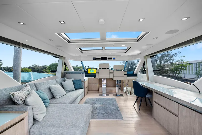 Slide: The Image of Luxurious interior of 2021 Monte Carlo Yachts MCY 76 Skylounge with modern seating and panoramic windows. - 15