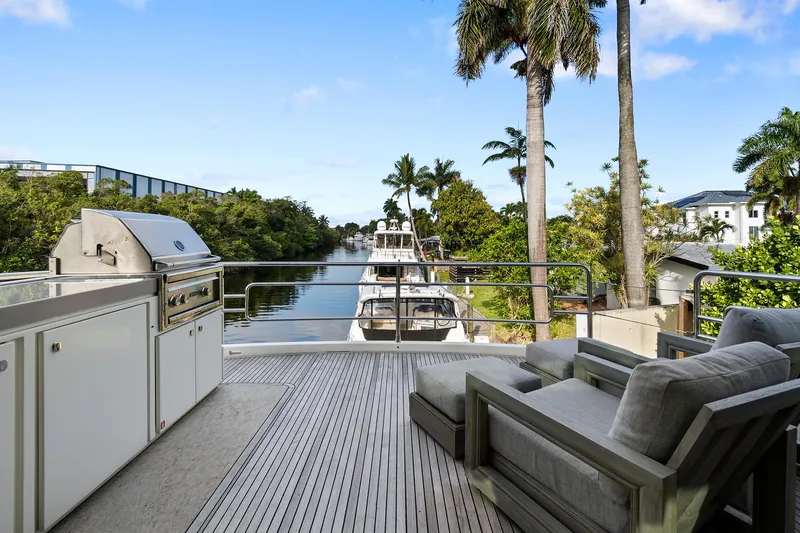 Slide: The Image of Luxury yacht deck with seating and grill, Monte Carlo Yachts MCY 76 Skylounge, 2021 model. - 21