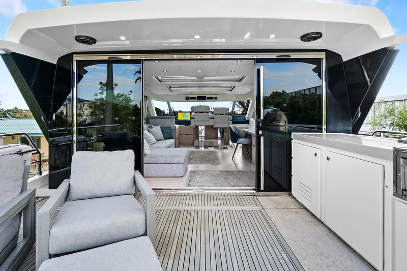 Slide: The Image of Luxurious 2021 Monte Carlo Yachts MCY 76 Skylounge interior with modern seating and sleek design. - 22