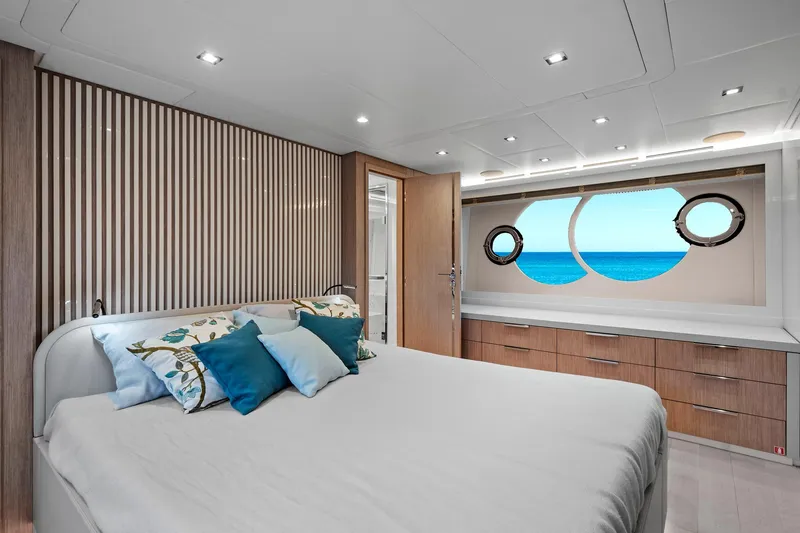 Slide: The Image of Luxurious bedroom interior of 2021 Monte Carlo Yachts MCY 76 Skylounge with ocean view. - 25