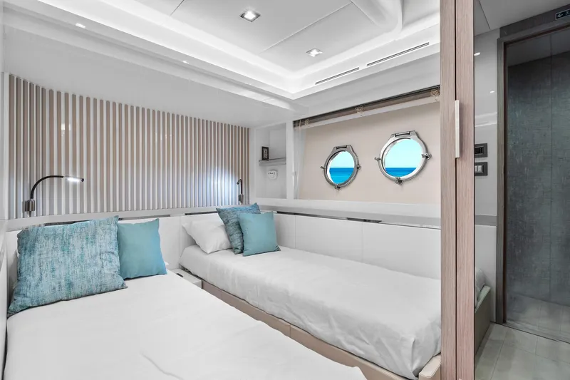 Slide: The Image of Luxurious cabin interior of 2021 Monte Carlo Yachts MCY 76 Skylounge with twin beds. - 32