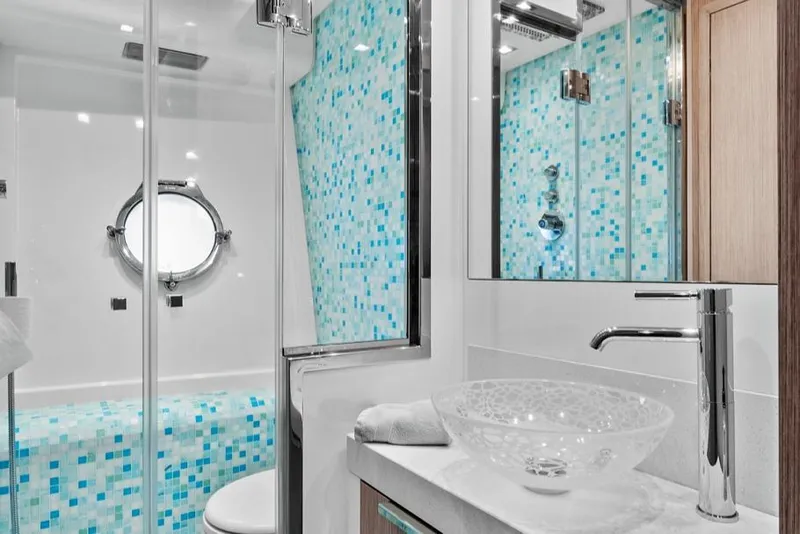 Slide: The Image of Luxurious bathroom in 2021 Monte Carlo Yachts MCY 76 Skylounge with mosaic tiles and glass sink. - 34