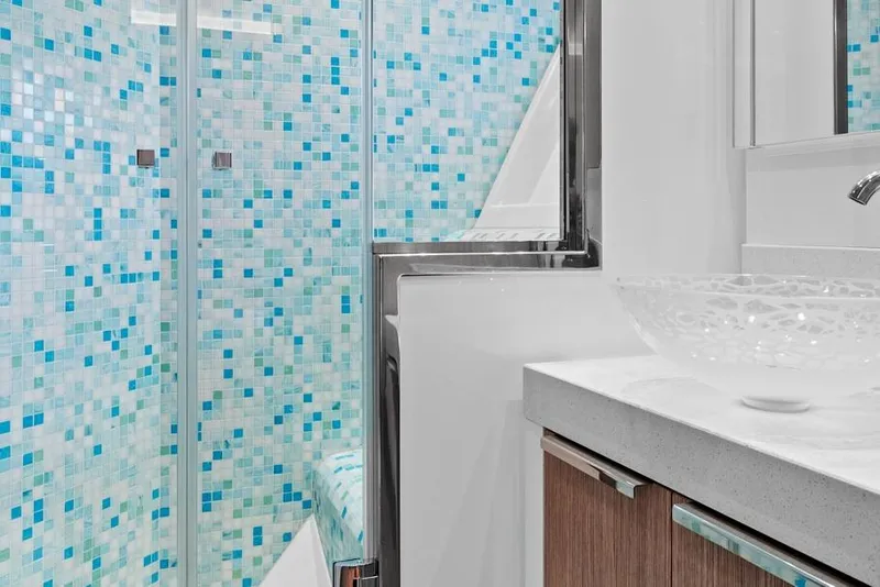 Slide: The Image of Luxurious bathroom in 2021 Monte Carlo Yachts MCY 76 Skylounge with mosaic tiles and glass sink. - 36