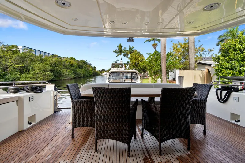 Slide: The Image of 2021 Monte Carlo Yachts MCY 76 Skylounge deck with outdoor dining area. - 4