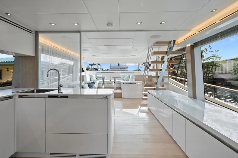 Slide: The Image of Luxurious interior of 2021 Monte Carlo Yachts MCY 76 Skylounge with modern kitchen and seating area. - 6