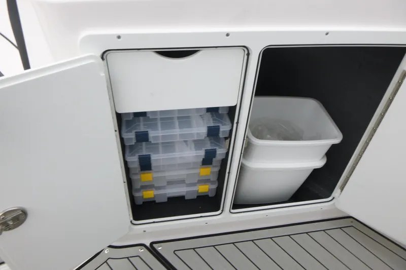 Slide: The Image of Storage compartments on 2026 Yamaha Boats 255 FSH Sport H, featuring organized bins and containers. - 10