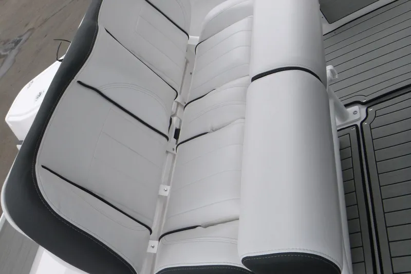 Slide: The Image of White cushioned seating on 2026 Yamaha Boats 255 FSH Sport H, featuring sleek design. - 11