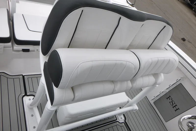 Slide: The Image of 2026 Yamaha Boats 255 FSH Sport H interior seating, featuring sleek white and black upholstery. - 12