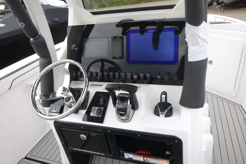 Slide: The Image of 2026 Yamaha Boats 255 FSH Sport H dashboard with steering wheel and controls. - 13