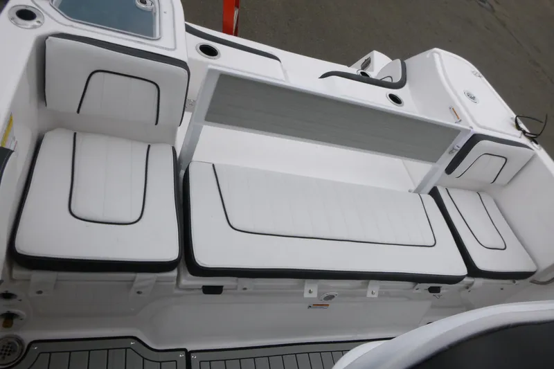 Slide: The Image of 2026 Yamaha Boats 255 FSH Sport H interior seating with white cushions and black trim. - 15