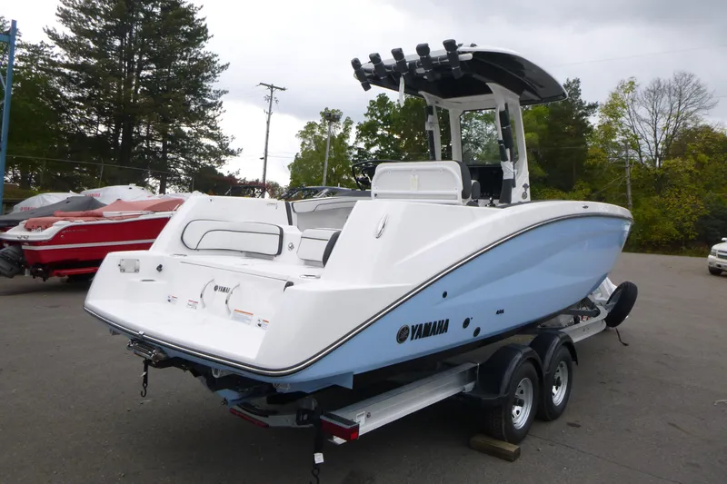 Slide: The Image of 2026 Yamaha Boats 255 FSH Sport H on trailer, parked outdoors. - 2