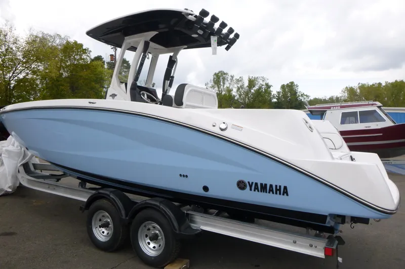 Slide: The Image of 2026 Yamaha Boats 255 FSH Sport H on trailer, sleek design, light blue hull. - 3