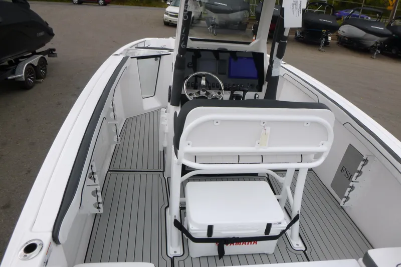 Slide: The Image of 2026 Yamaha Boats 255 FSH Sport H interior with helm and seating. - 4