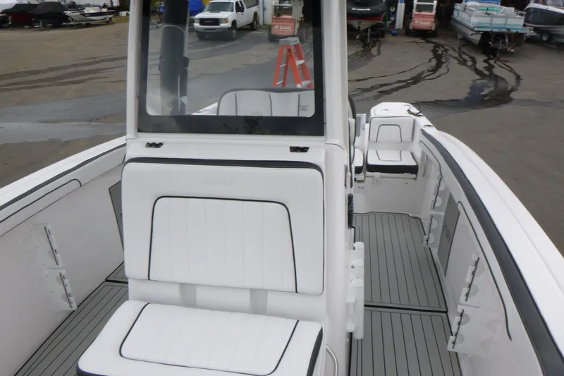 Slide: The Image of 2026 Yamaha Boats 255 FSH Sport H interior with white seating and sleek design. - 5