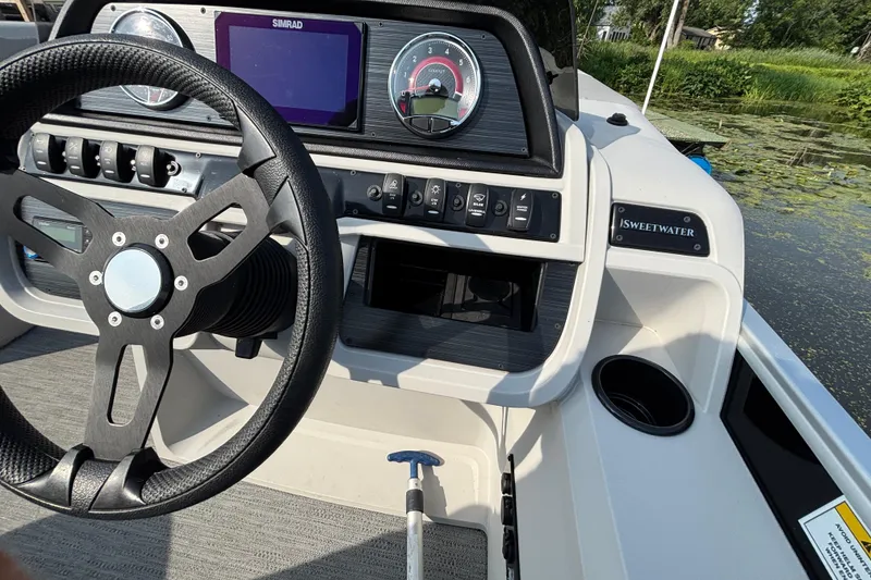 Slide: The Image of Steering console of 2025 Godfrey Sweetwater SW2286MT boat with Simrad display. - 5