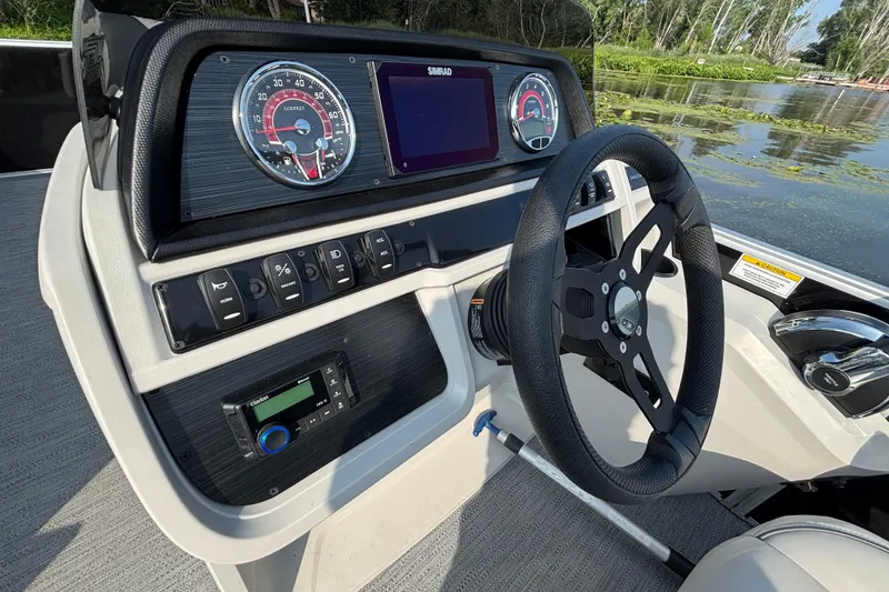 Slide: The Image of Steering console of 2025 Godfrey SW2286MT boat with gauges and controls. - 6