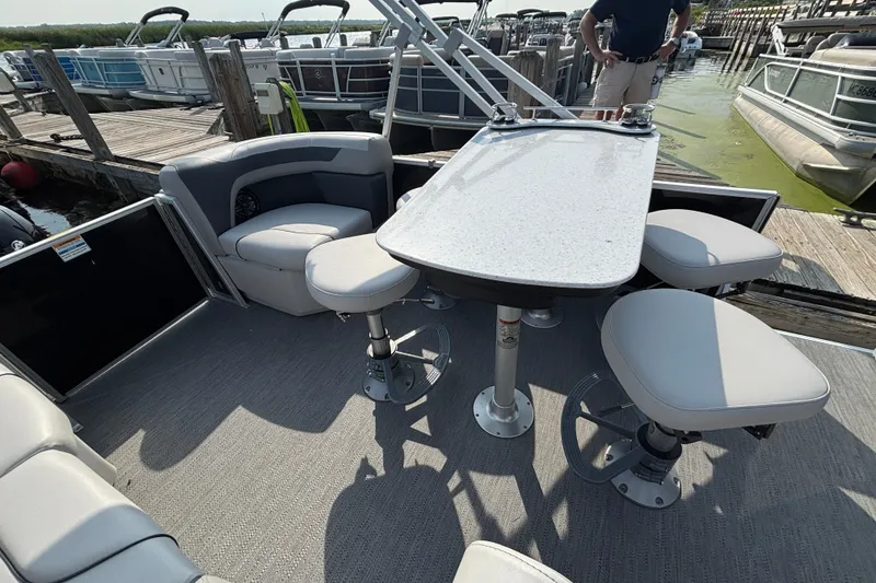 Slide: The Image of Pontoon boat interior with seating and table, docked at marina. Godfrey SW2286MT, 2025 model. - 9