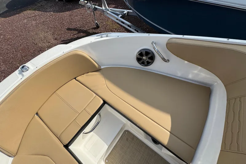 Slide: The Image of 2021 Sea Ray SPX 190 Outboard boat interior with tan seating and speaker. - 10