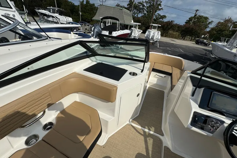 Slide: The Image of 2021 Sea Ray SPX 190 Outboard interior with tan seating and modern dashboard. - 13