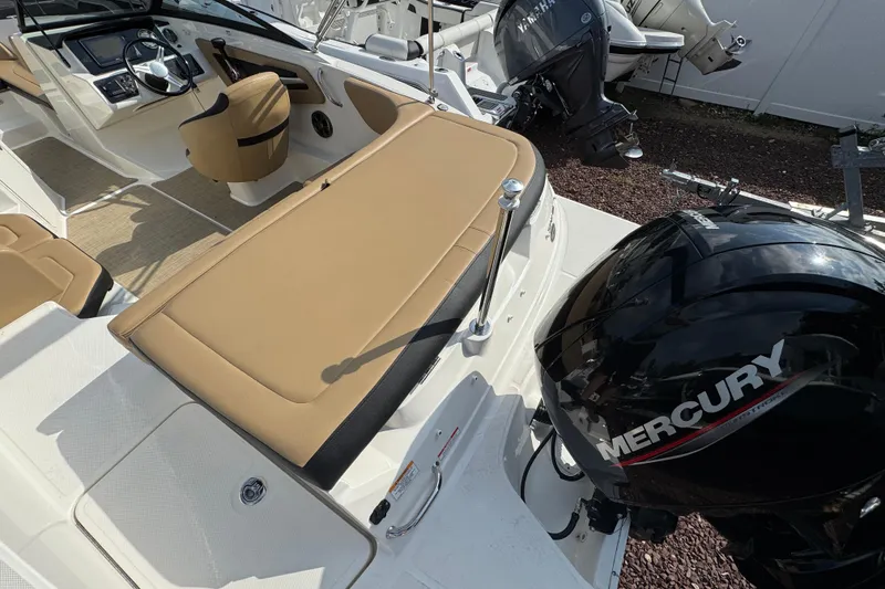Slide: The Image of 2021 Sea Ray SPX 190 Outboard boat interior with Mercury engine, tan seating, and steering console. - 15