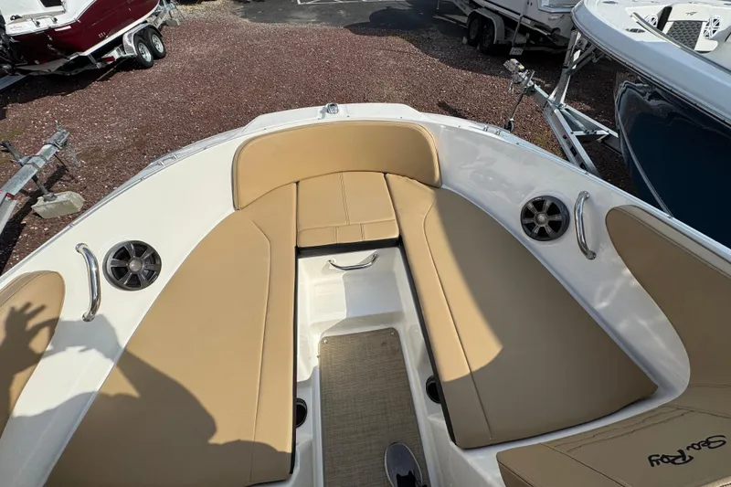 Slide: The Image of 2021 Sea Ray SPX 190 Outboard boat interior with tan seating and speakers. - 18