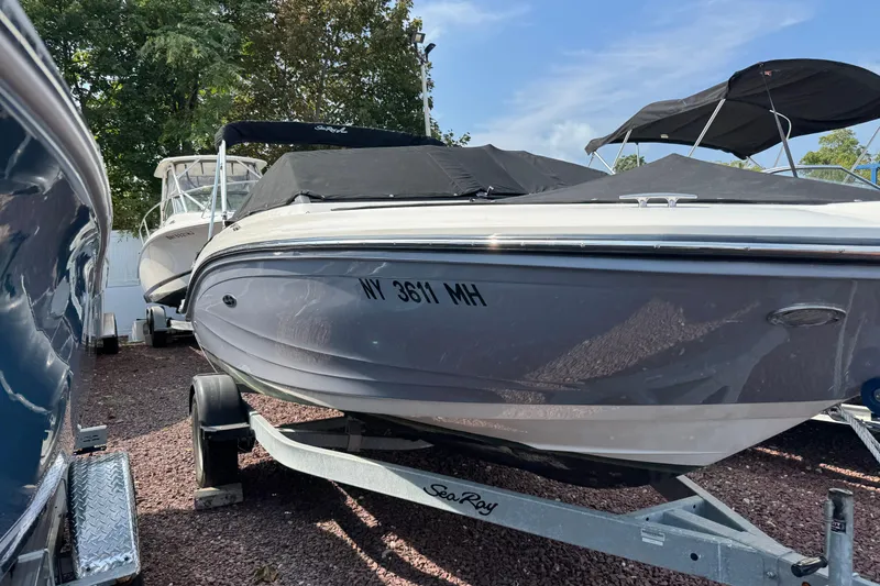 Slide: The Image of 2021 Sea Ray SPX 190 Outboard boat on trailer, covered and parked outdoors. - 2