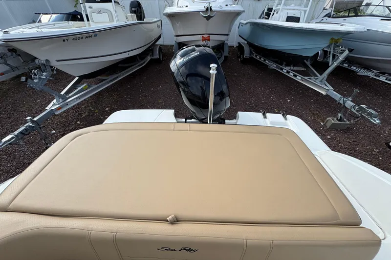 Slide: The Image of 2021 Sea Ray SPX 190 Outboard boat with beige seating, parked among other boats. - 22