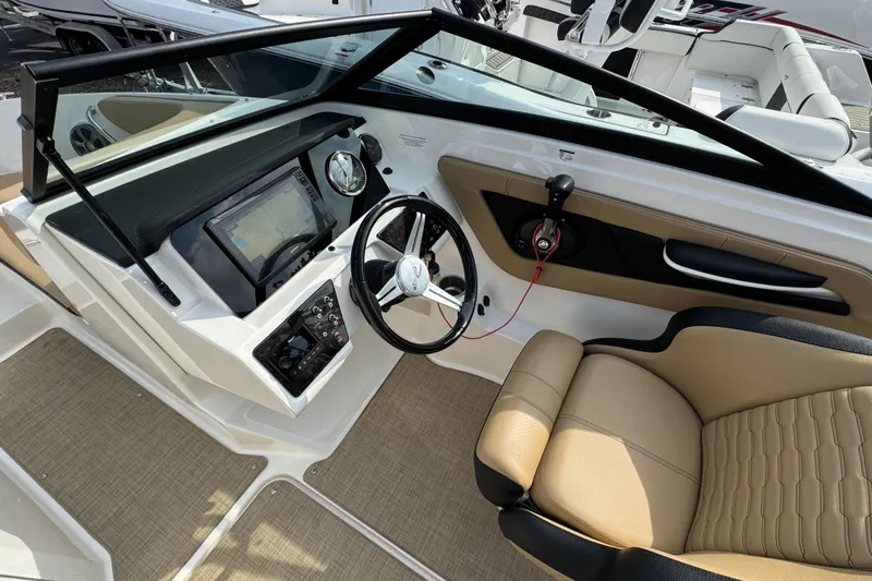 Slide: The Image of 2021 Sea Ray SPX 190 Outboard boat interior with steering wheel and dashboard controls. - 6