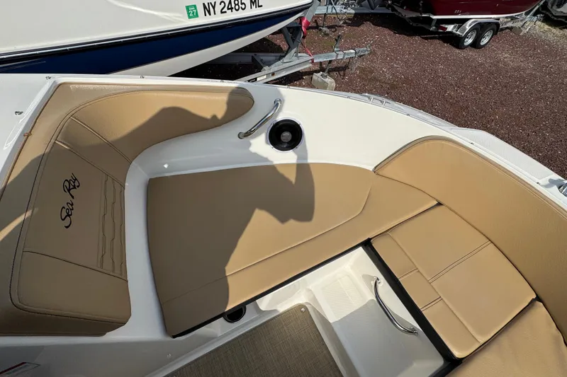 Slide: The Image of 2021 Sea Ray SPX 190 Outboard boat interior with tan seating and logo. - 9
