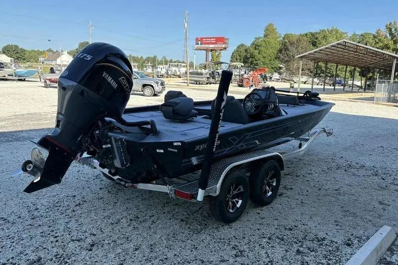 Slide: The Image of 2026 Xpress H20 Bass boat with Yamaha motor on a trailer in a parking lot. - 10