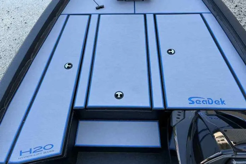 Slide: The Image of 2026 Xpress H20 Bass boat deck with SeaDek flooring, featuring sleek design and storage compartments. - 11
