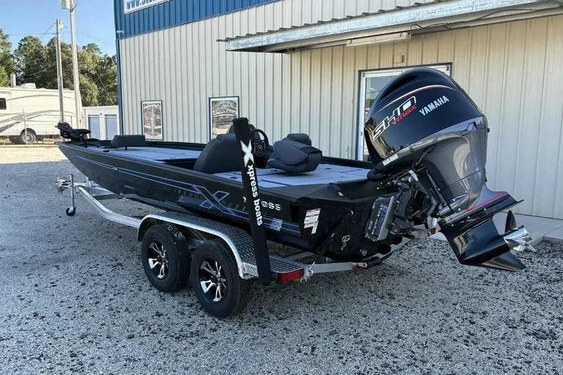 Slide: The Image of 2026 Xpress H20 Bass boat with Yamaha engine on trailer, parked outside. - 12