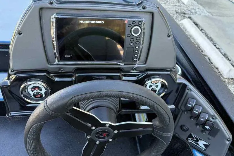 Slide: The Image of 2026 Xpress H20 Bass boat dashboard with steering wheel and Humminbird Helix 7 display. - 6