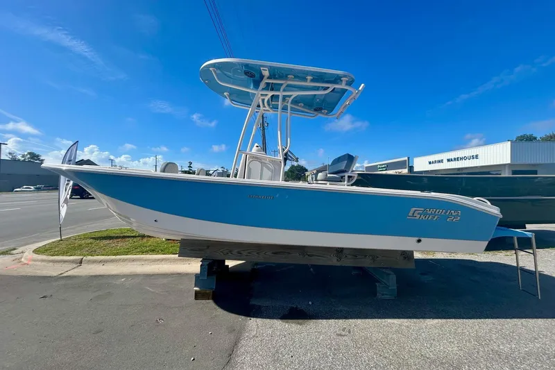 Slide: The Image of 2026 Carolina Skiff 22 Ultra Elite boat displayed outdoors on a sunny day. - 0
