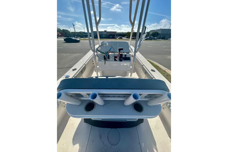 Slide: The Image of 2026 Carolina Skiff 22 Ultra Elite boat interior with steering wheel and rod holders. - 3