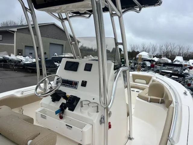 Slide: The Image of 2020 Key West 239 FS boat with steering console and seating, docked outdoors. - 16