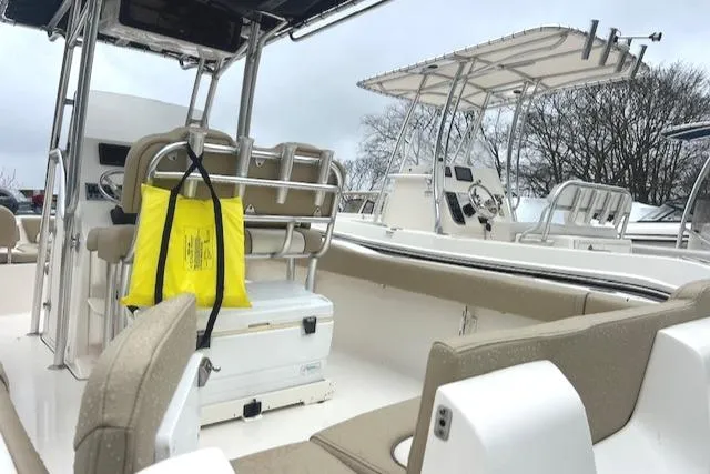 Slide: The Image of 2020 Key West 239 FS boat interior with seating and equipment, overcast sky. - 17