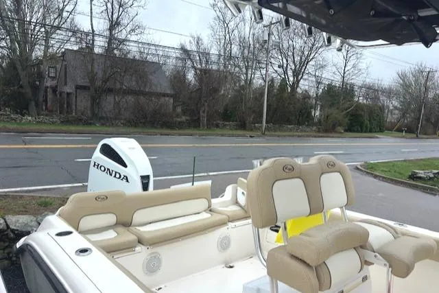 Slide: The Image of 2020 Key West 239 FS boat with Honda engine, parked near a road. - 19