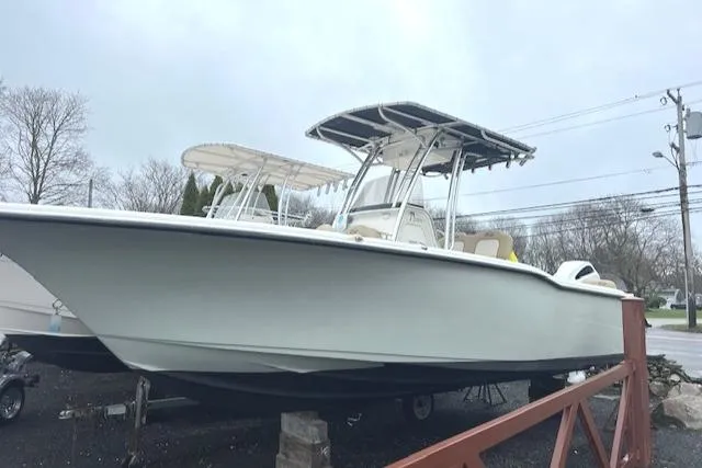 Slide: The Image of 2020 Key West 239 FS boat on display, featuring a sleek design and T-top canopy. - 2