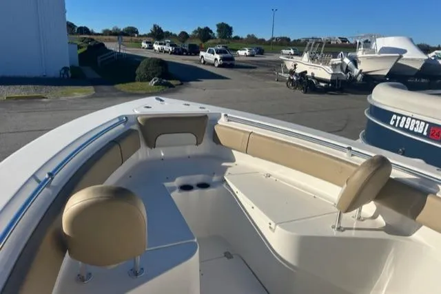 Slide: The Image of 2020 Key West 239 FS boat with beige seating, parked in a marina. - 6