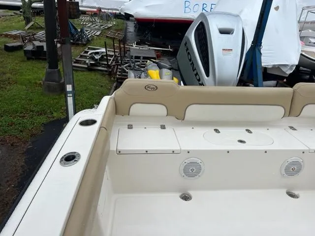 Slide: The Image of 2020 Key West 239 FS boat interior with Honda outboard motor, docked outdoors. - 7