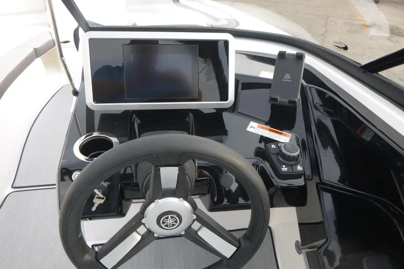Slide: The Image of 2026 Yamaha Boats AR250 dashboard with steering wheel, touchscreen, and controls. - 10