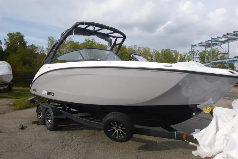 Slide: The Image of 2026 Yamaha Boats AR250 on trailer, parked outdoors, under cloudy sky. - 3