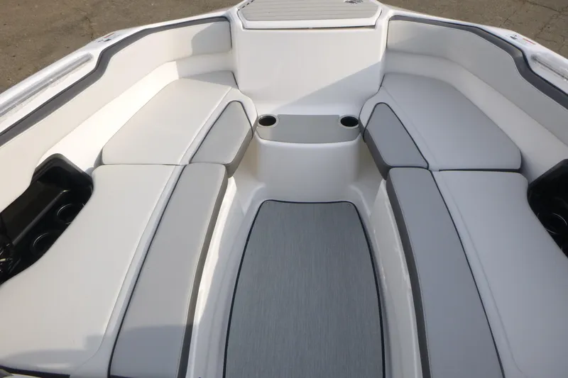Slide: The Image of 2026 Yamaha Boats AR250 interior with cushioned seating and cup holders. - 6